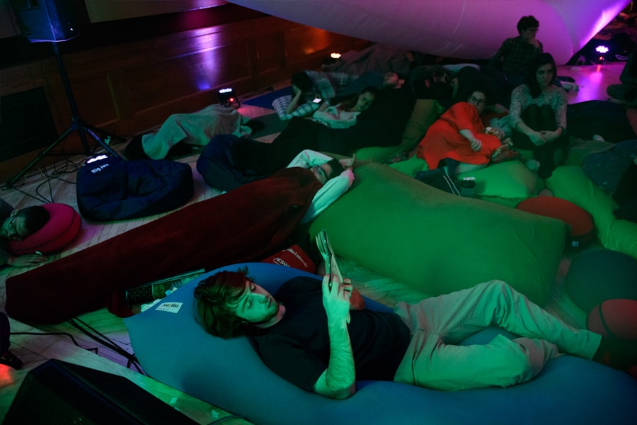 Attendees recline and read books during the Snoozefest overnight concert at Carnegie Mellon