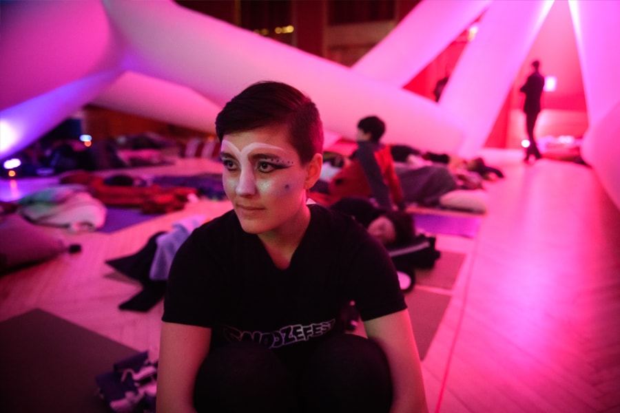 Student Valerie Senavsky sits among the dream-like environment made of inflatable sculptures and ambient music at the Snoozefest event at Carnegie Mellon